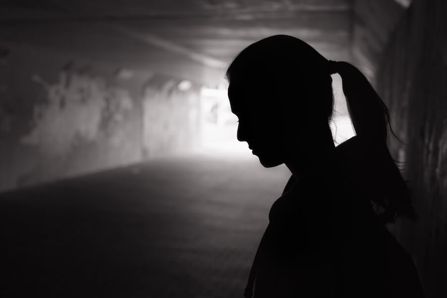 A photo of a depressed, sad person outside