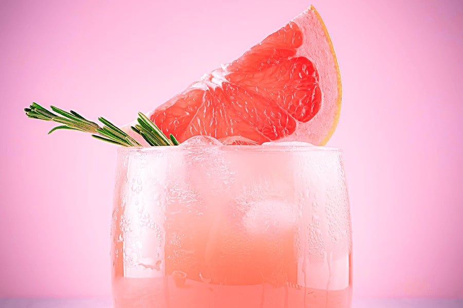 A photo of a Paloma cocktail with a grapefruit garnish
