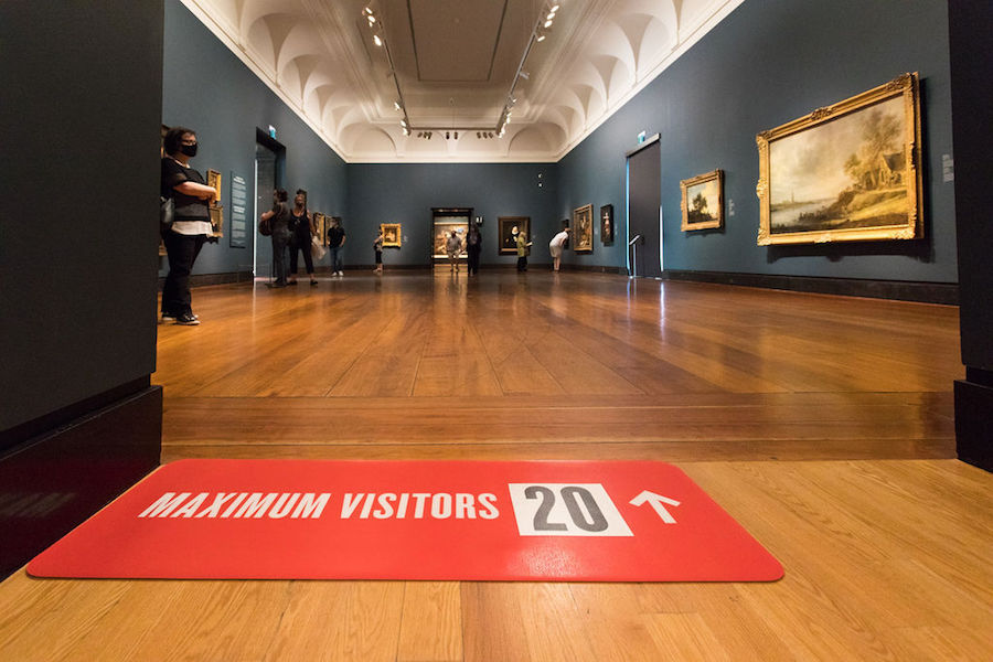 A mat indicating 20 visitors are allowed in an The Art Gallery of Ontario room.