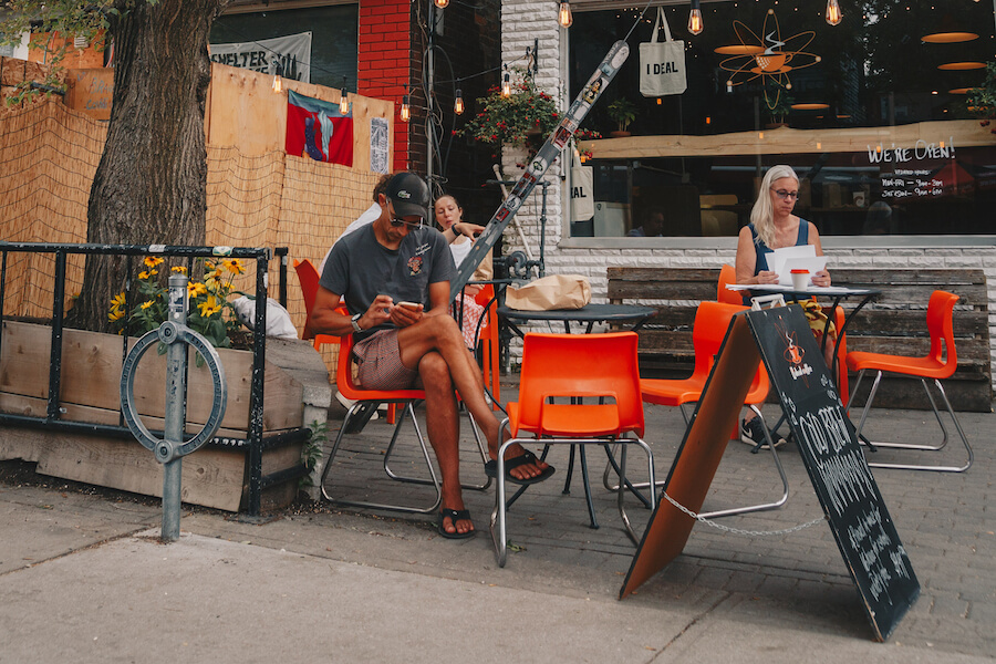 People sit on the I Deal Coffee patio at 84 Nassau in Kensington Market