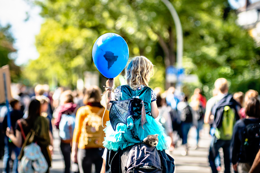 A girl holds a balloon during a climate crisis protest in Bonn, Germany in September 2019