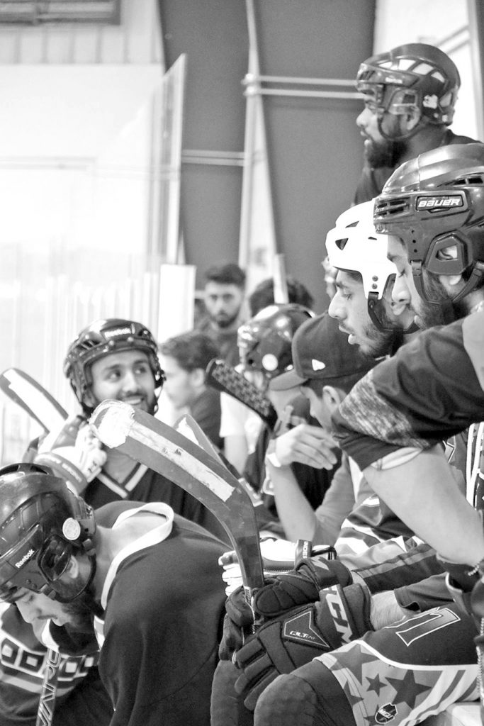 A black-and-white photo of hockey players