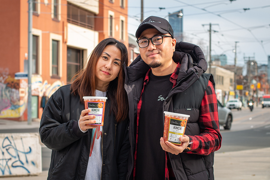 Su Jin Won (left) and Mike Won pose in Toronto with their vegan and non-vegan kimchi