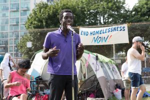 Desmond Cole at a press conference for encampment residents in summer 2021