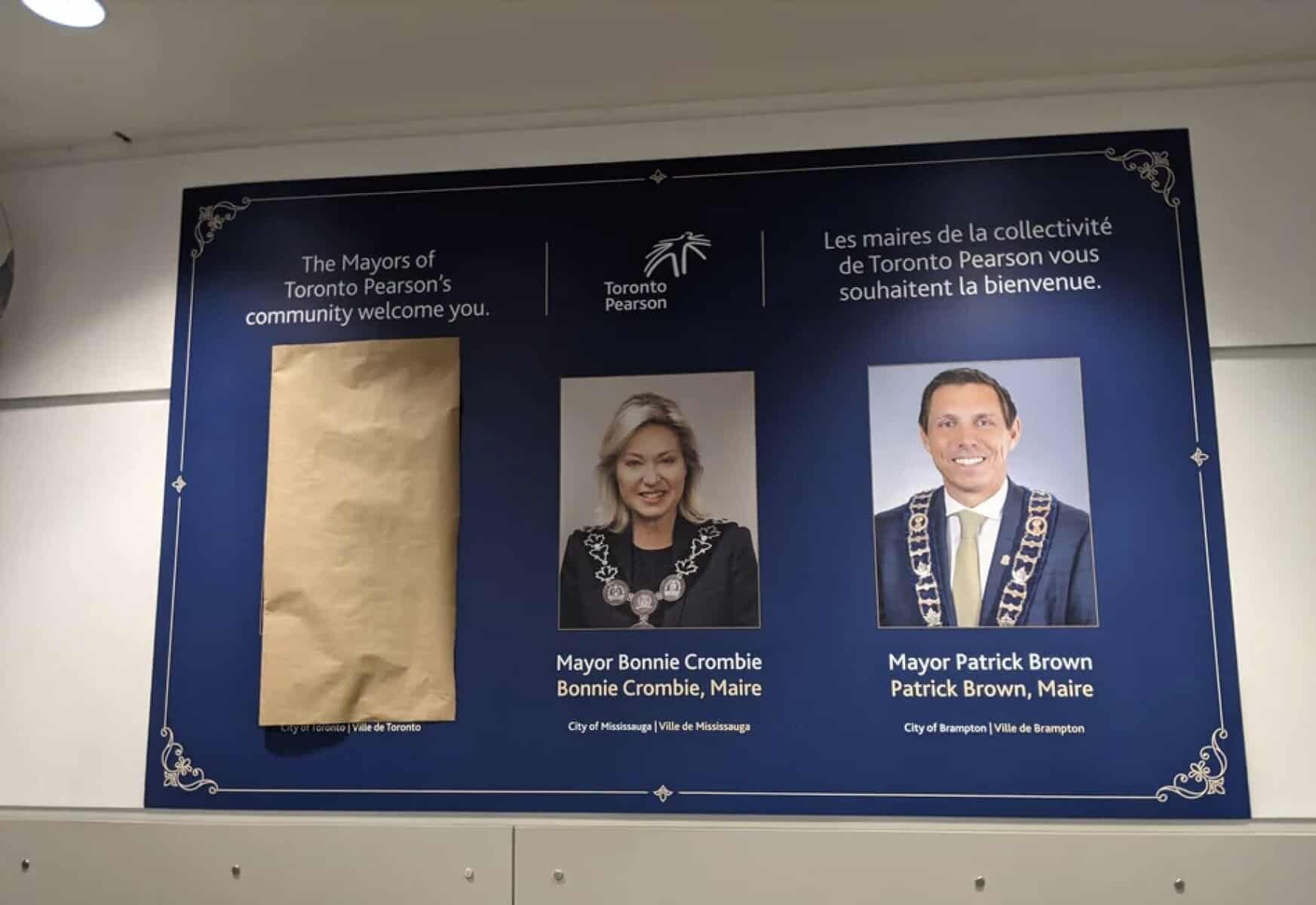 Toronto Pearson mayoral welcome sign with photos of Bonnie Crombie and Patrick Brown at Toronto airport, showcasing city leadership and civic pride in Toronto, Ontario.