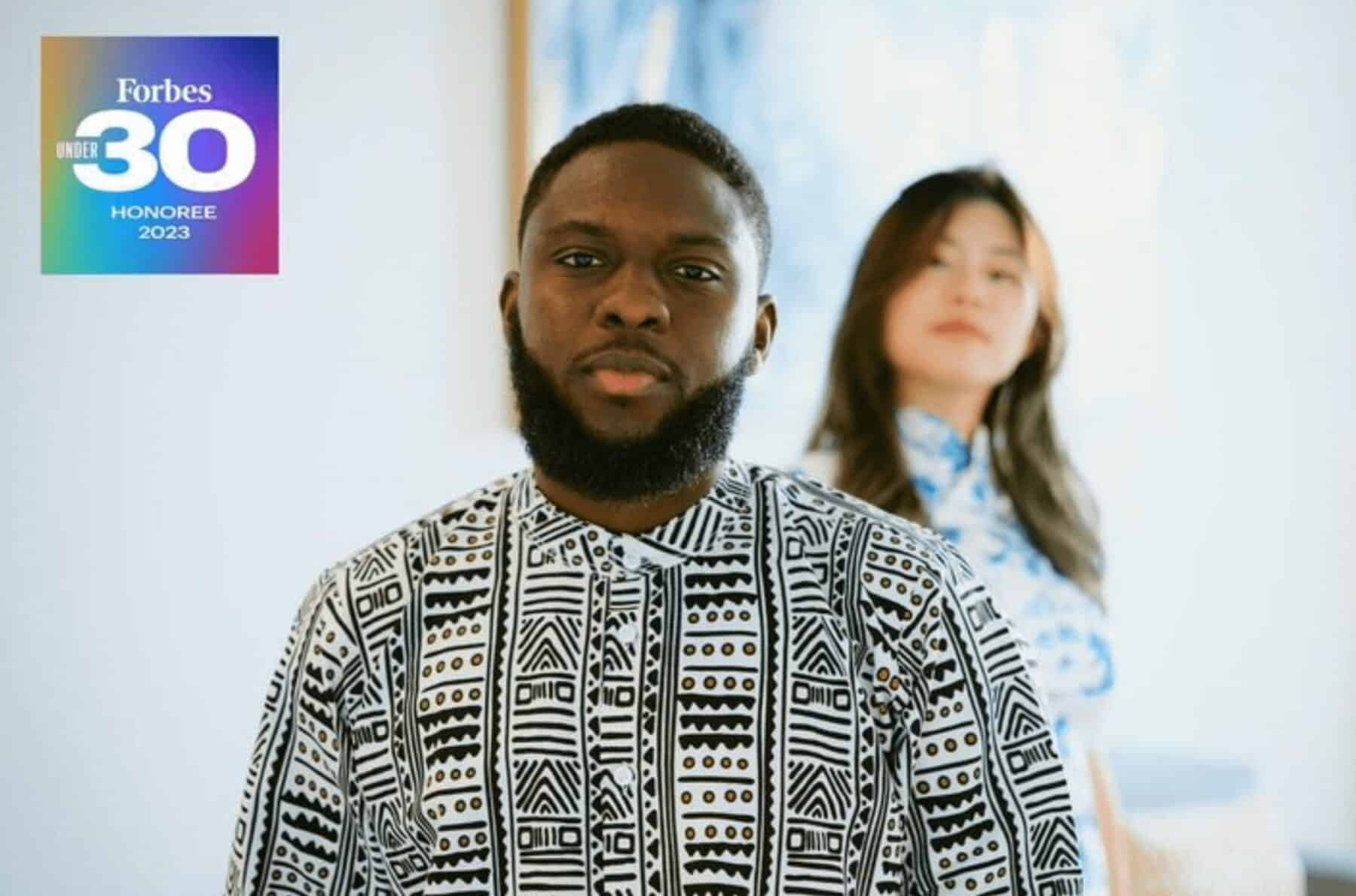 Diverse group of young professionals standing indoors, showcasing Toronto's vibrant workplace culture, with Forbes Under 30 Honouree badge in the top left corner for networking excellence.