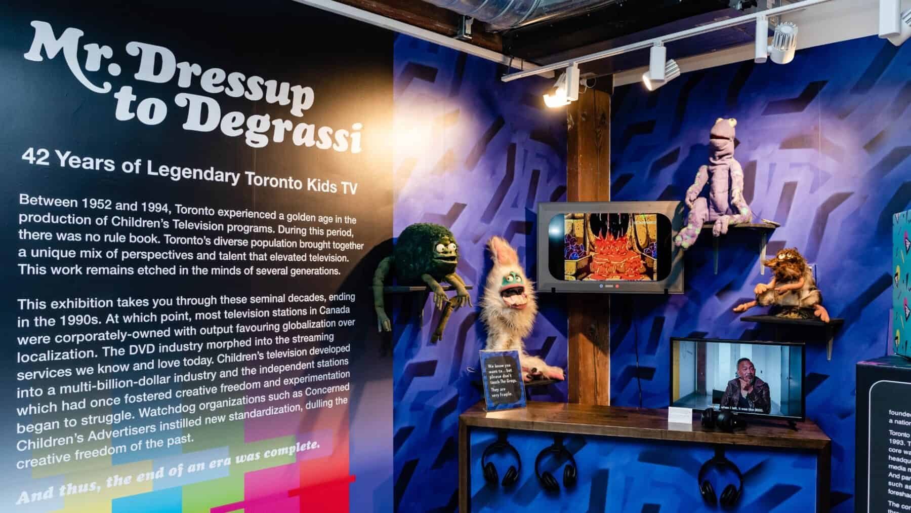 Vibrant exhibit celebrating 42 years of Toronto Kids TV history with puppets and retro television displays at NOW Toronto.