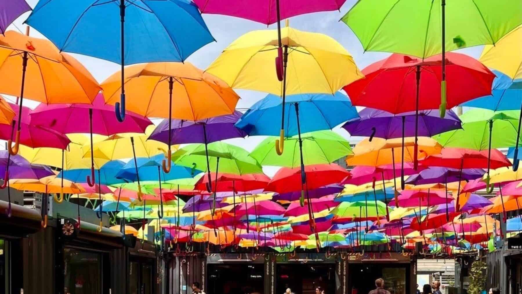 Colorful umbrellas installation in Toronto city street, vibrant outdoor art display, popular tourist attraction, urban art, weather protection, vibrant cityscape, Toronto outdoor decor, arts and culture.