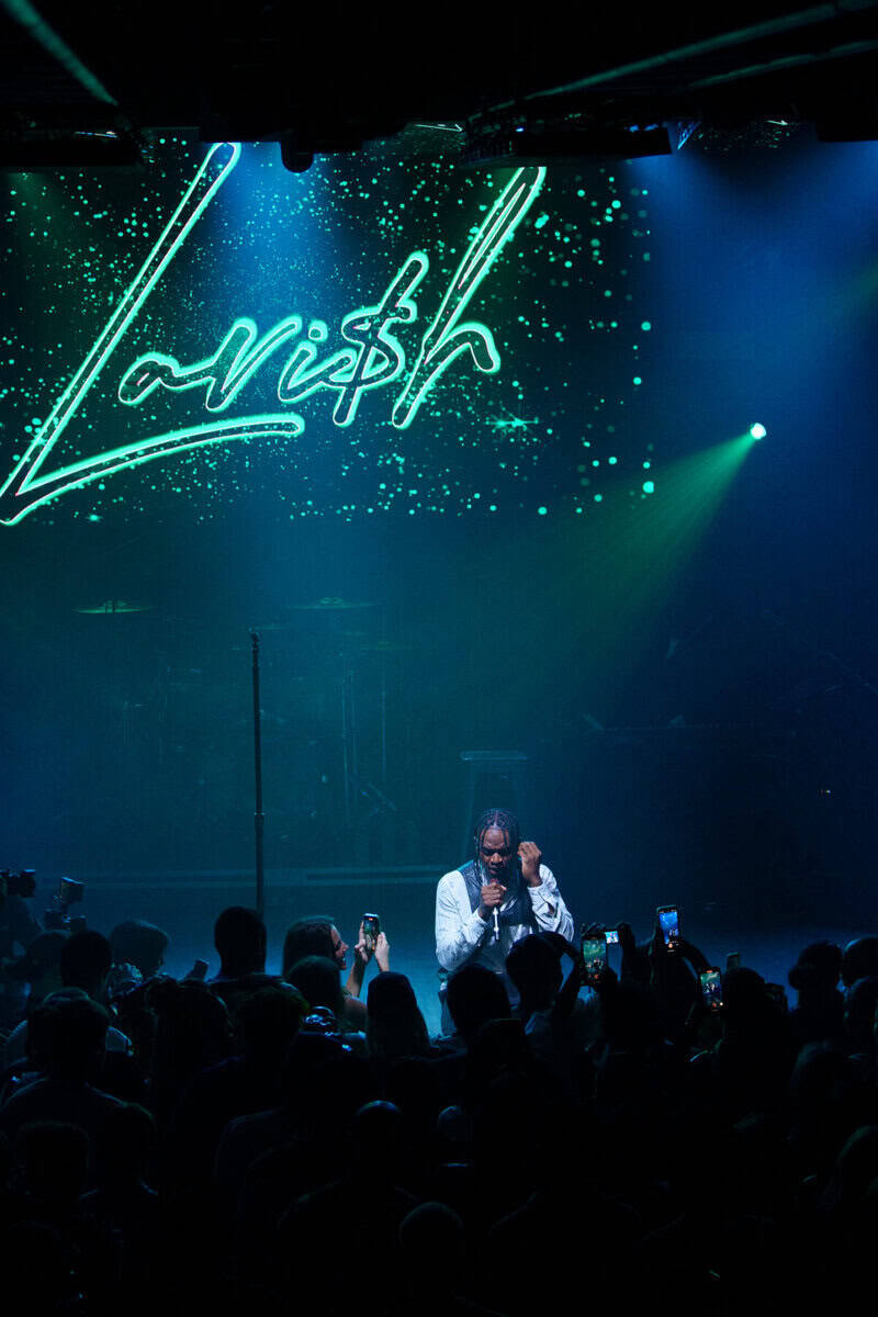 Vibrant live performance at NOW Toronto event with neon "Virish" sign, energetic crowd, and dynamic stage lighting highlighting Toronto’s premier entertainment scene.