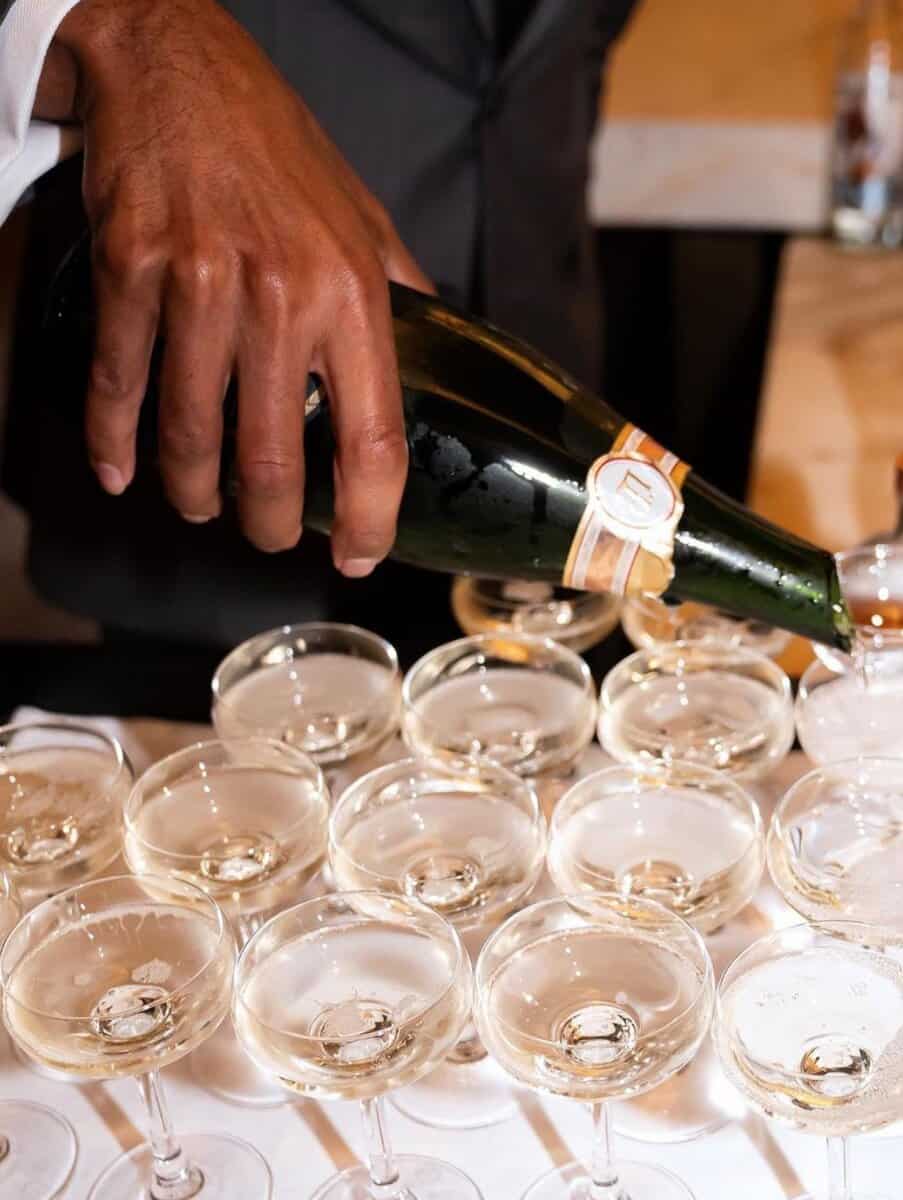 Filling champagne glasses at a celebration event in Toronto, celebrating Toronto nightlife and events.