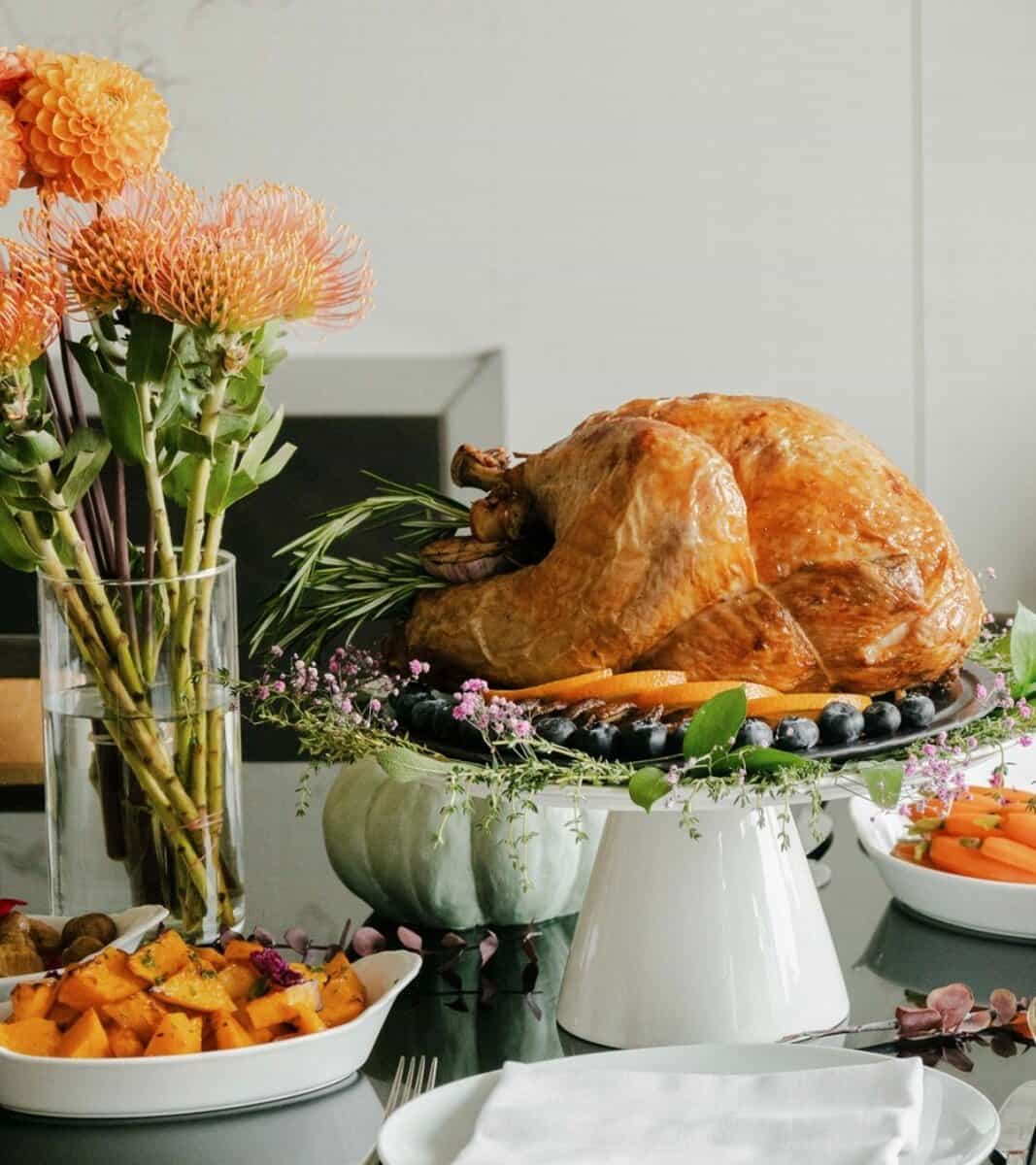 Succulent roasted turkey served on a festive dinner table with side dishes and floral centrepiece, perfect for holiday celebrations in Toronto.