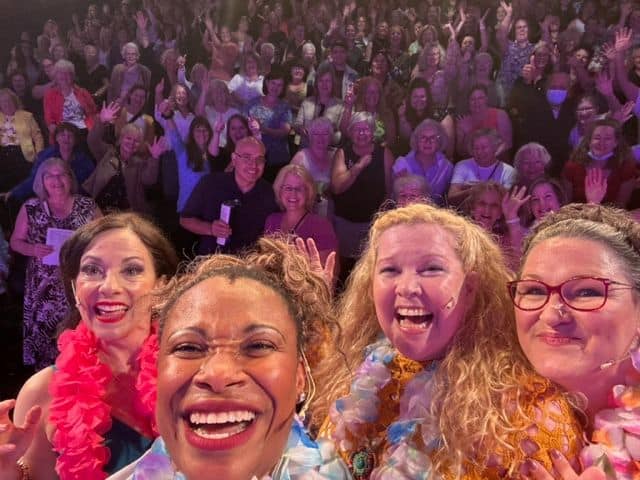 Crowd at a lively event in Toronto, diverse group of people enjoying a celebration or concert, vibrant atmosphere, NOW Toronto coverage.