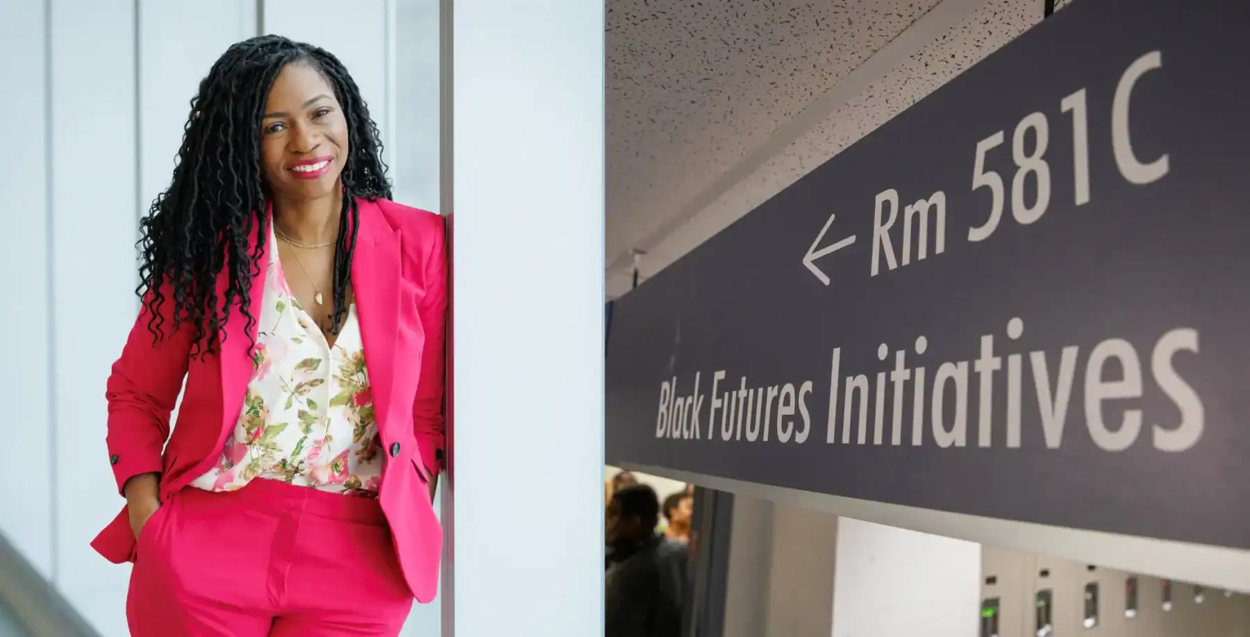 Vibrant professional woman in pink suit at Black Futures Initiatives event in Toronto.