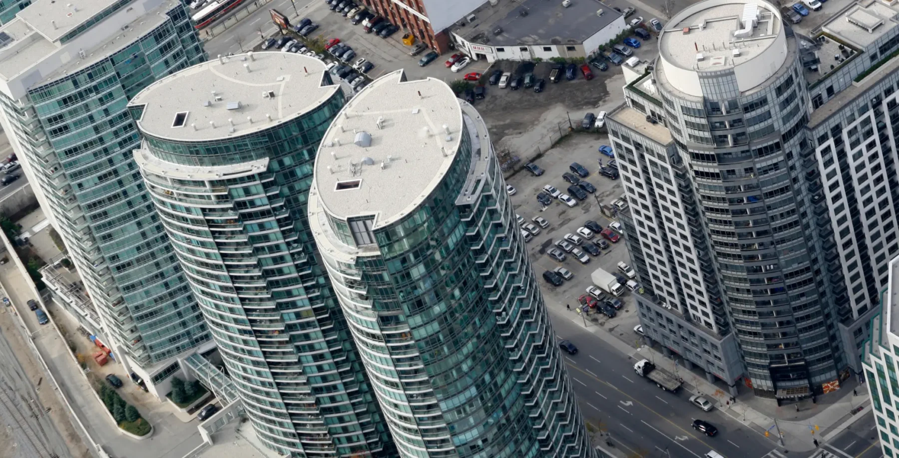 Skyline of Toronto high-rise buildings with glass facades and street view, urban architecture, downtown Toronto skyscrapers.