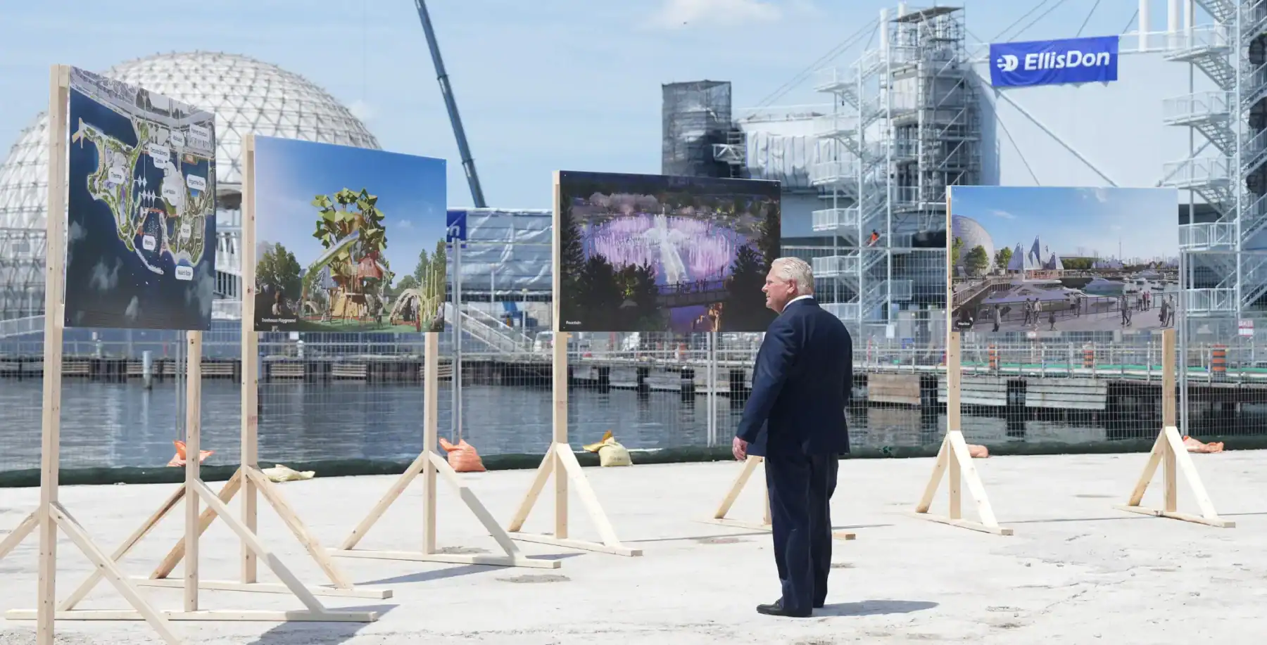 Construction site overlooking Toronto's waterfront with outdoor art exhibits, showcasing urban development and city planning visuals.