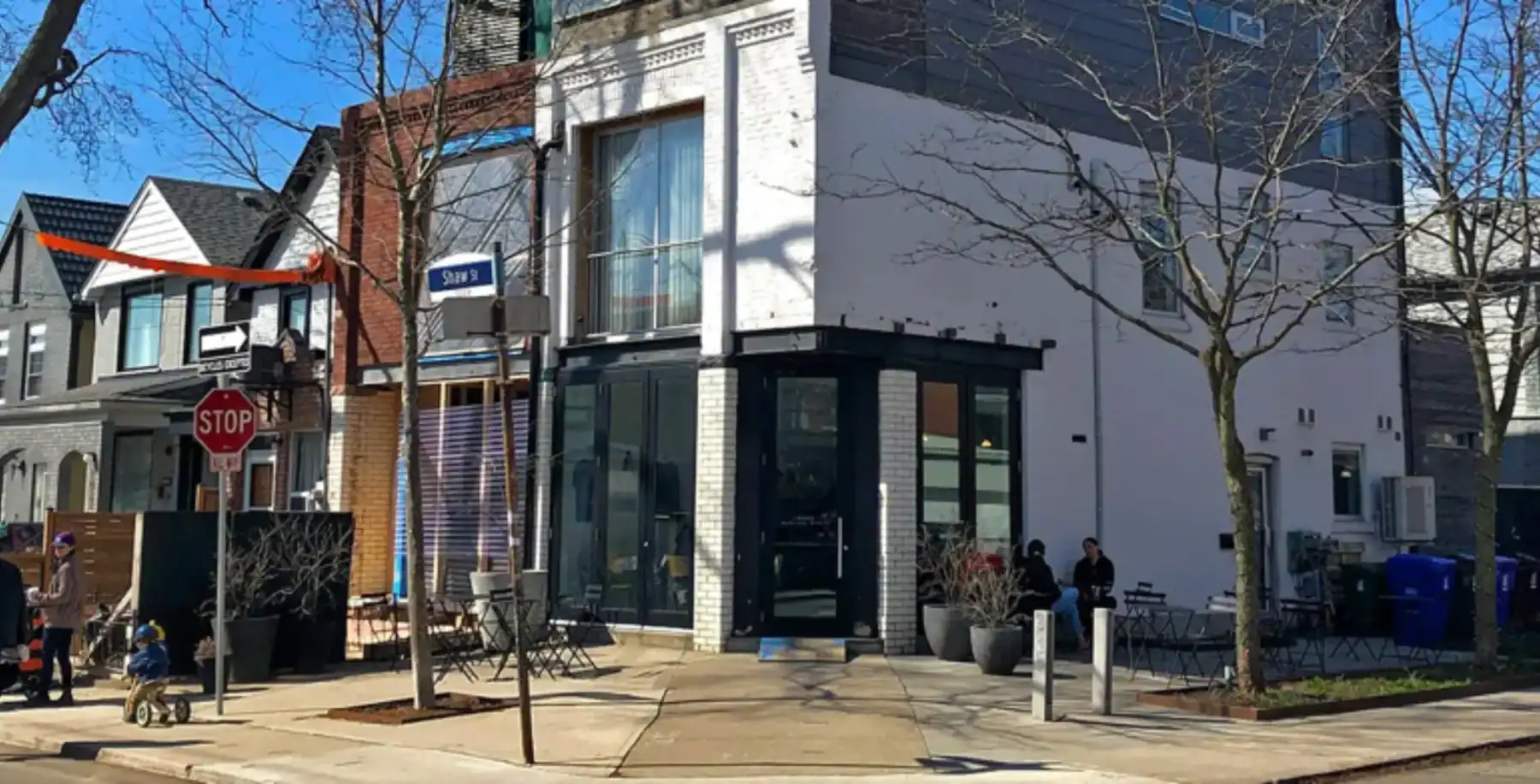 Modern urban neighbourhood in Toronto with stylish cafes and outdoor seating.