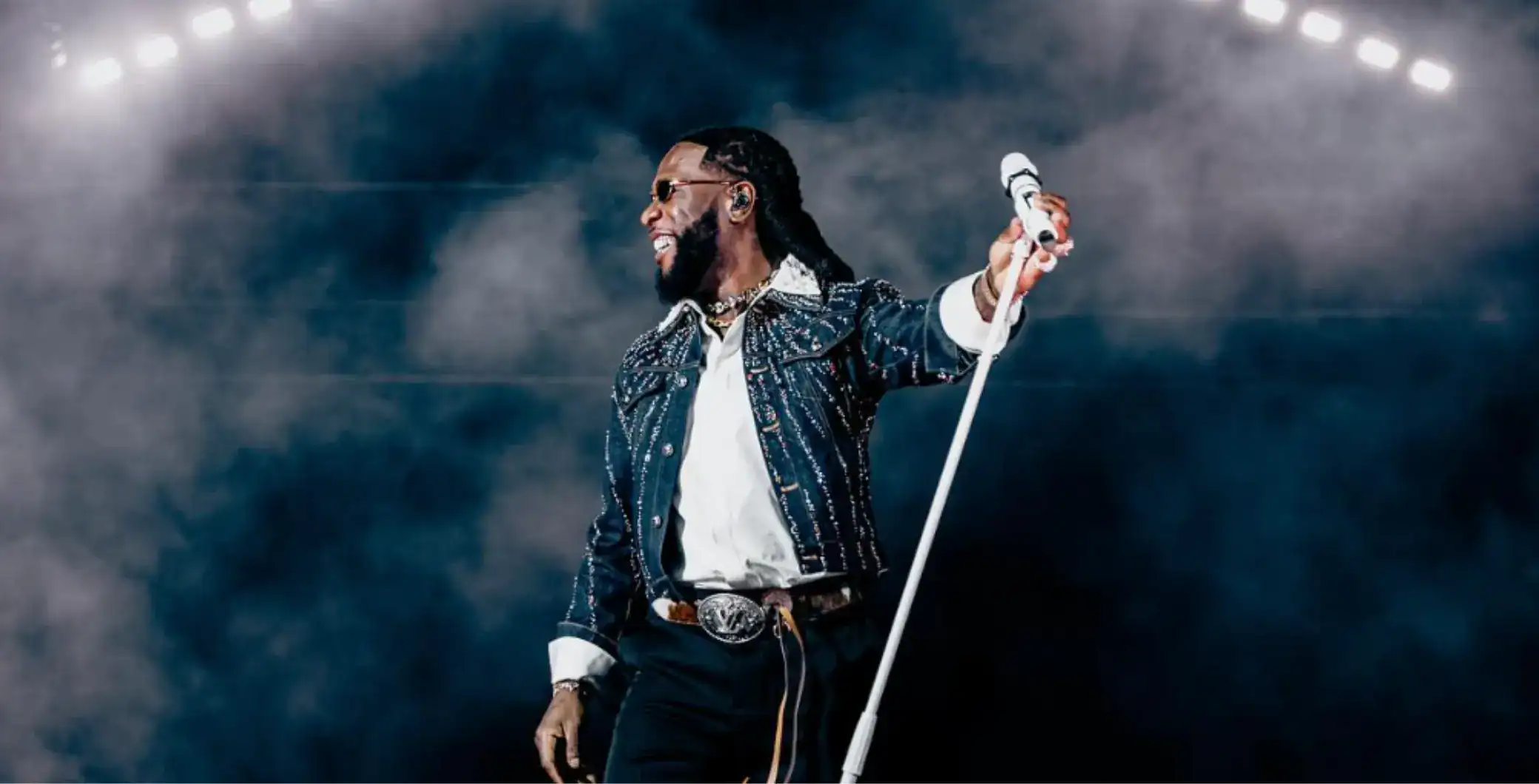 Vibrant live concert performance of a male singer with a microphone on stage, energetic atmosphere, music event in Toronto, Canada.