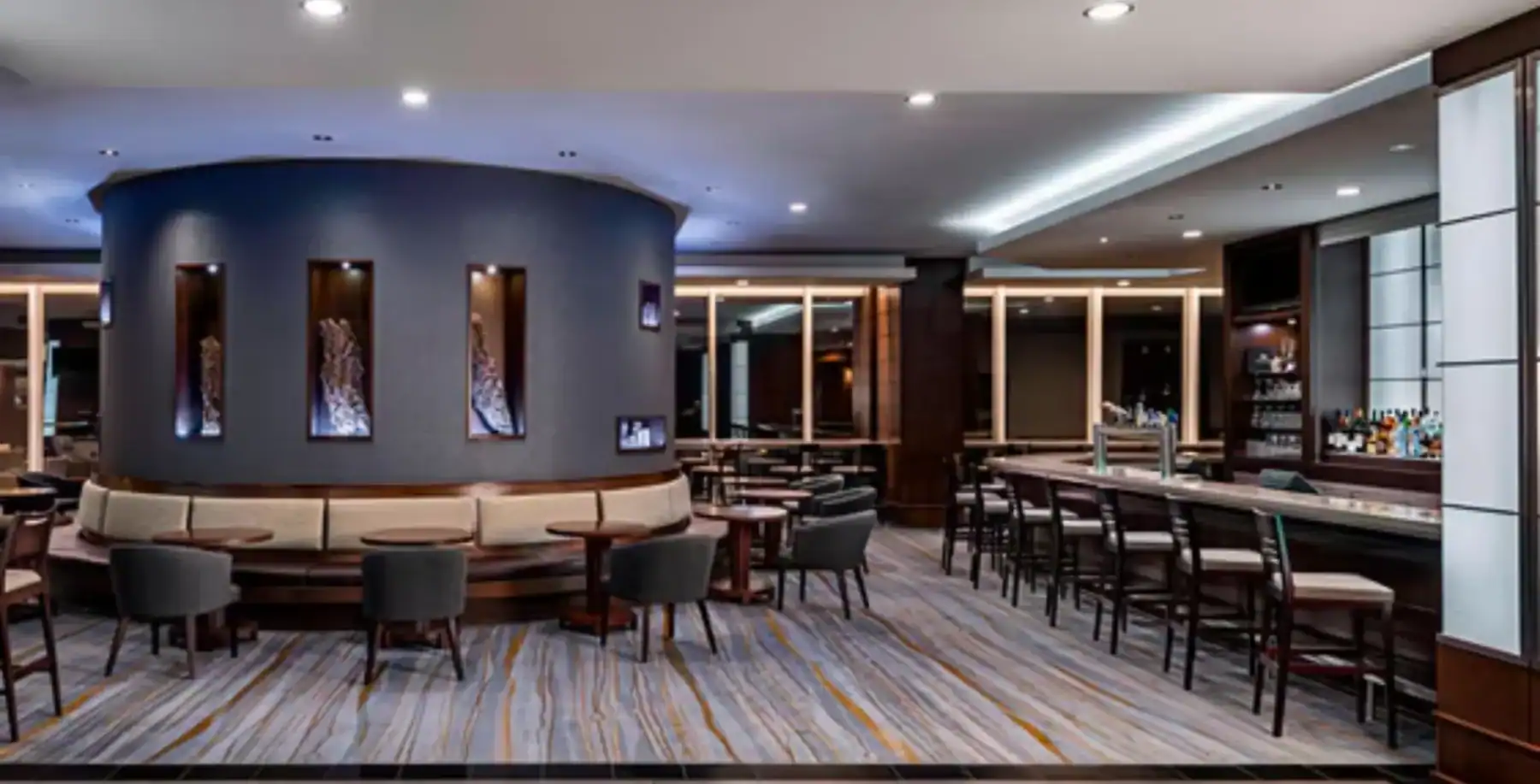 Modern upscale bar interior with stylish seating and contemporary lighting in Toronto.
