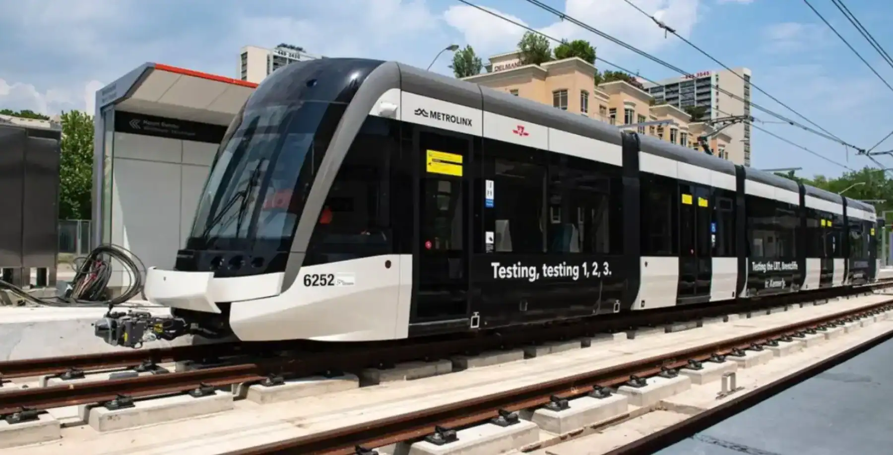 Modern Toronto transit train testing on elevated tracks in downtown Toronto.
