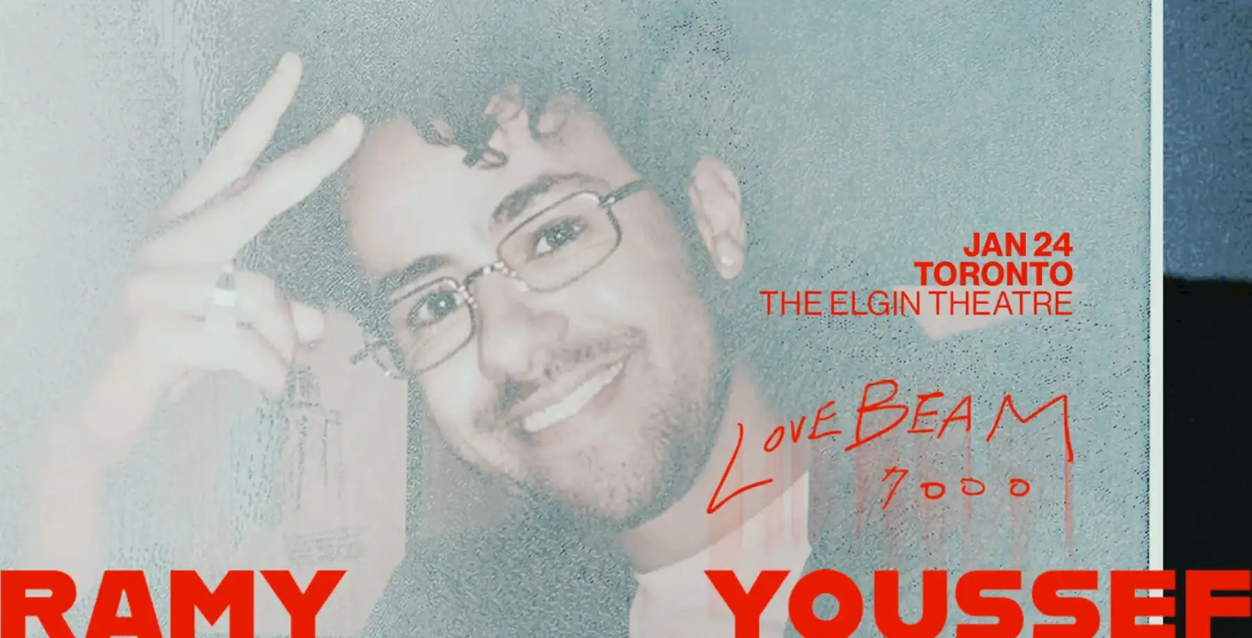 Bright smiling man with glasses behind a glass panel with event details for Now Toronto.