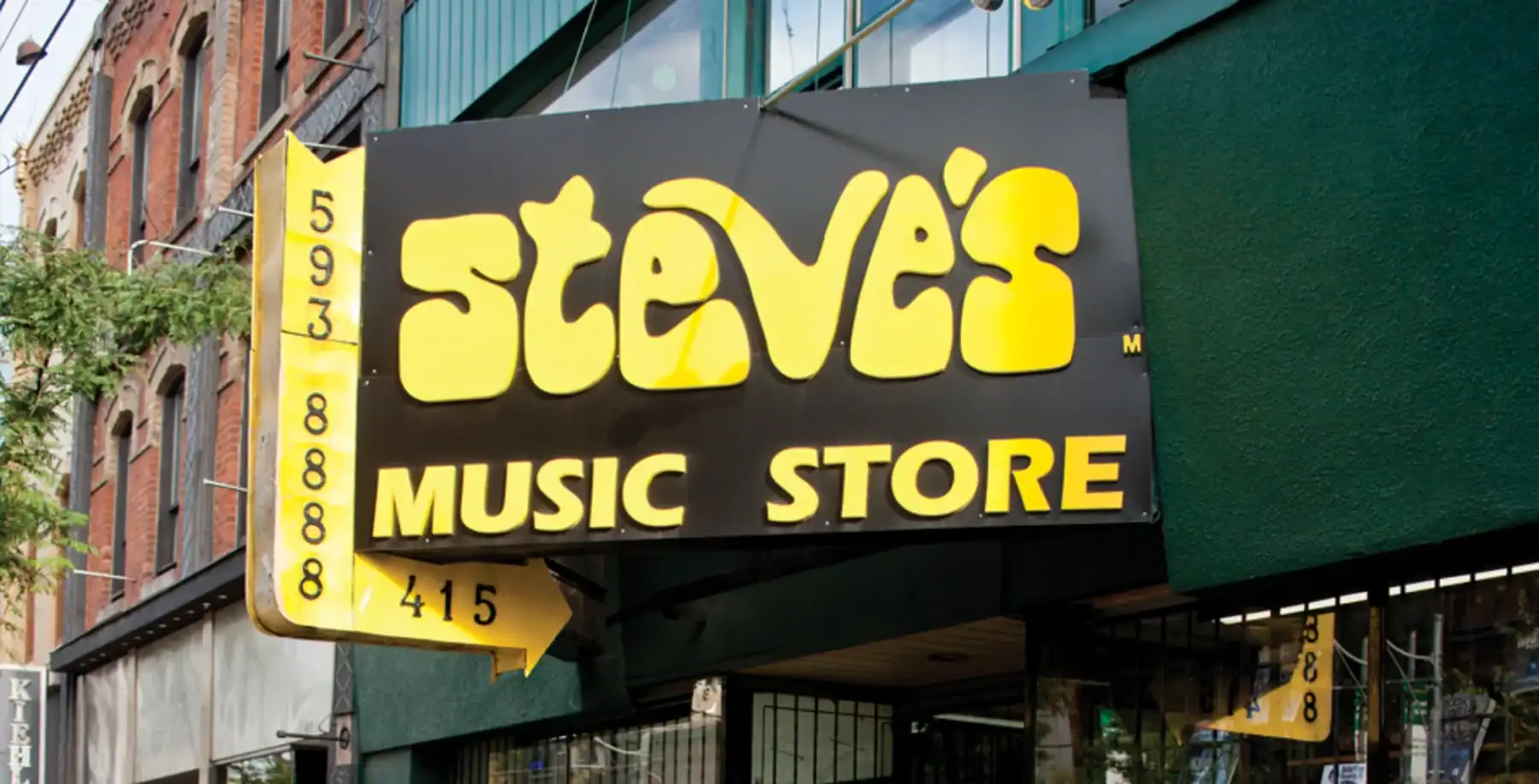 A close-up of the iconic Steve’s Music Store sign on Queen West, Toronto, marking nearly 50 years of musical history and community significance.