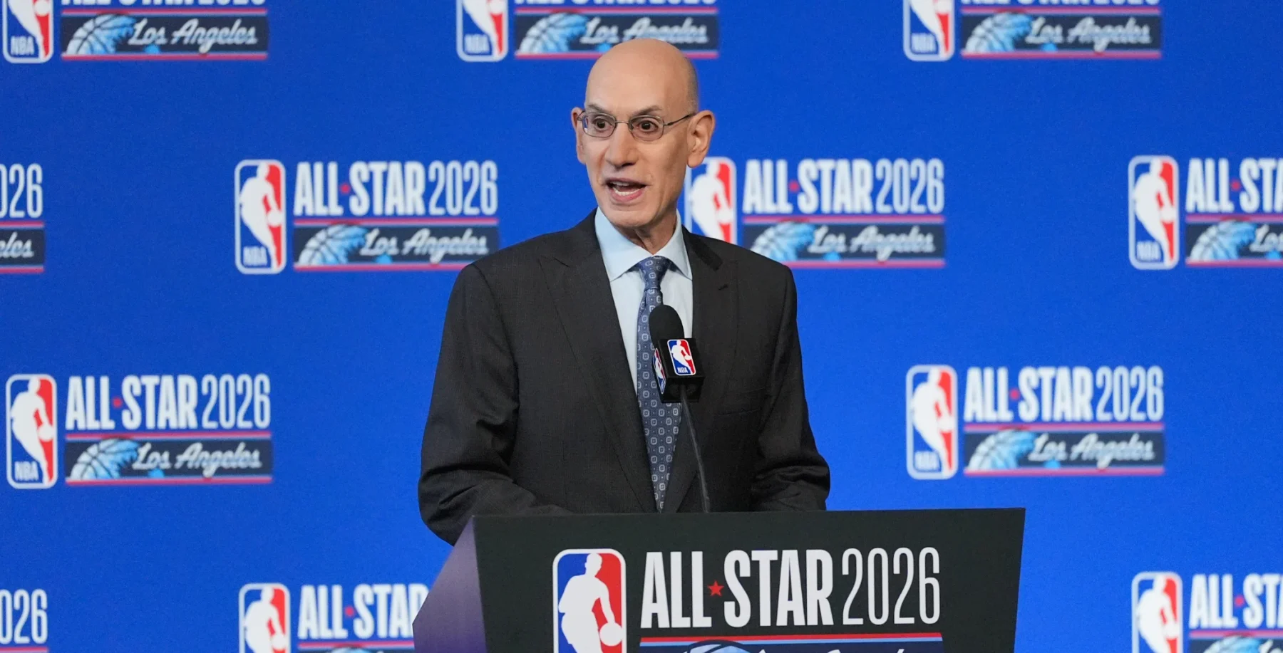 Toronto NBA All-Star 2026 event featuring a speaker at a podium with NBA All-Star branding in the background.
