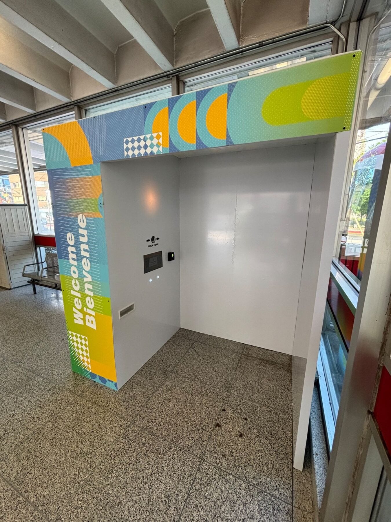 Colorful Toronto transit station entrance with a vibrant "Welcome to Bloor Street" sign, featuring modern design elements and large windows providing natural light.