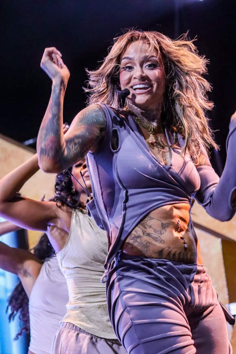 Kehlani performing on stage in Toronto, showcasing her energetic dance moves and vibrant style during a live concert.