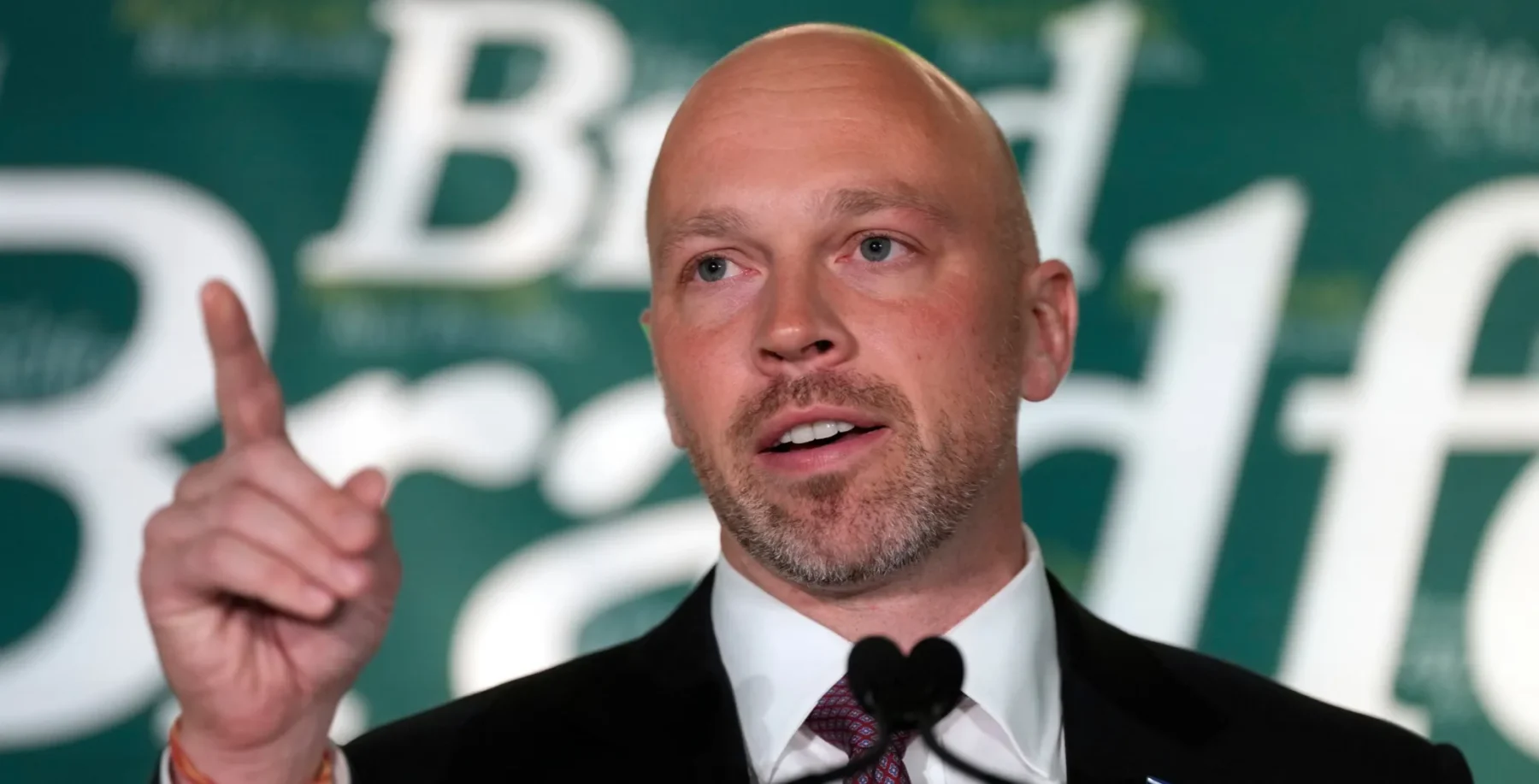 Brad Bradford speaks at a campaign event, raising his index finger as he delivers a heartfelt concession speech after Toronto mayoral election loss (NOW Toronto, en_CA).