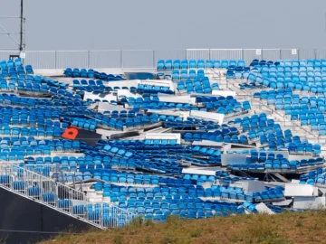 Torn-out blue stadium seats at Rogers Stadium after a severe Toronto storm, with some seats displaced and damaged.